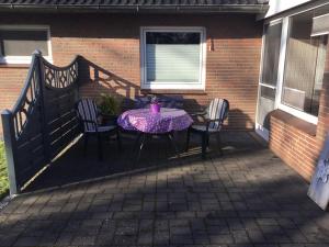 a patio with a table and chairs on a balcony at Haus "Sonnenschein" in Breklum