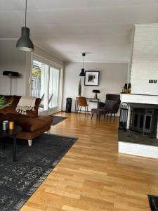 a living room with a couch and a fireplace at Koslig bolig med sjøutsikt in Asker