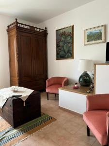 a living room with a cabinet and a table at Lilly & Gisa casa vacanze in Pedara