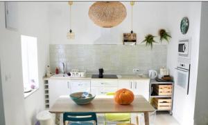 a kitchen with a table with a pumpkin on it at Casa Rural Recovecos in Algodonales