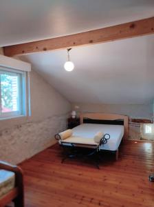 een kamer met een bed op een zolder met een raam bij Halte Mobilité Professionnelle au Mois in Agen