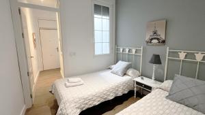 - une chambre avec 2 lits et une fenêtre dans l'établissement Wallada San Hipólito, à Cordoue