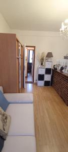 a living room with a white couch and a kitchen at Evasion du Stade in Saint-Denis +1 photo