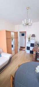 a bedroom with a bed and a room with a table at Evasion du Stade in Saint-Denis