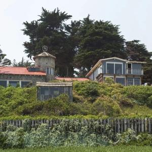 una casa en la cima de una colina con una valla en Cabañas la Playa, en Isla Negra