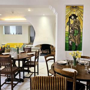 a dining room with tables and chairs and a fireplace at Hôtel Candide in Saint-Bertrand-de-Comminges +57 photos