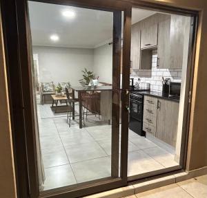 a kitchen with a view of a dining room at Hansen@15 Self Catering Studio in Piet Retief