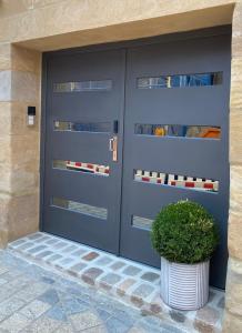 une porte de garage bleue avec une plante dans un pot dans l'établissement Stilvolles Apartment in Bayreuther Fußgängerzone, à Bayreuth