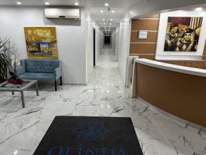 a lobby with a hallway with a blue couch and a carpet at Olinda Hotel & Spa in Sile