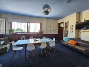 sala de estar con mesa, sillas y sofá en Montevideo Hostel, en Montevideo