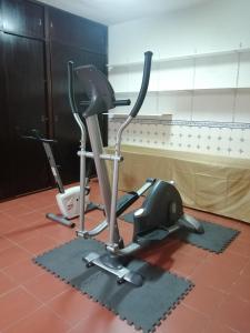 a gym with two exercise bikes in a room at Good Sleep in Santarém
