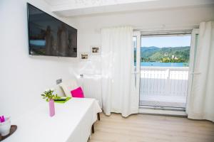 a living room with a white couch and a large window at Čarman House in Bled