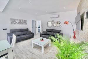 a living room with a couch and a table at Villa MARABÚ,piscina privada en Conil de la Frontera in Conil de la Frontera