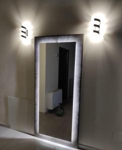 a mirror on a wall in a room with lights at B&B Celeste - Palazzo D'Addario in Celenza Valfortore +53 photos
