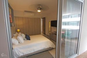 a bedroom with a bed and a sliding glass door at The Gallery Condos Playa de Carmen in Playa del Carmen