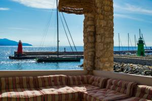 a living room with a couch and a red lighthouse at LA GUARDIA Hotel in Giglio Porto