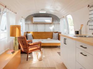 a kitchen and living room with a couch in a trailer at Ofland Escalante in Escalante