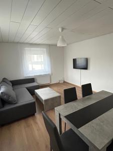 a living room with a couch and a table at Ferienwohnungen in Heidenheim in Heidenheim an der Brenz