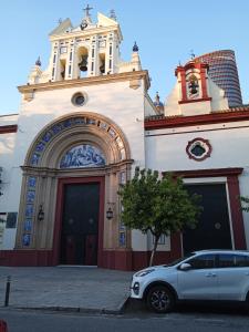 a white car parked in front of a building at Apartamento El Cachorro de Triana in Seville +13 photos