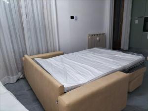 a large bed in a room with a white mattress at CASA REGINA in Crevoladossola