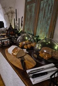 a table with bread and glass domes on it at Bed and Breakfast Les Airelles in Val-des-Prés