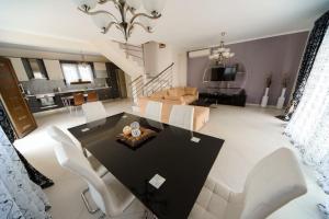 a living room with a table and chairs and a couch at Villas Hanioti in Hanioti