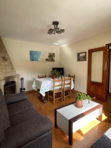 a living room with a couch and a table at La Ventana de Picos in Onís