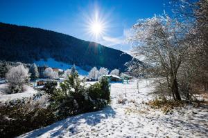 a snow covered field with the sun in the sky at La belle Agathe, Vercors in Le Guâ