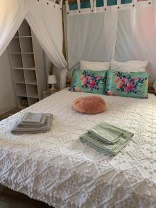 a bed with towels and pillows on it at La Petite Provence in Villes-sur-Auzon