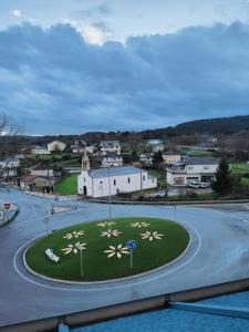 a roundabout with flowers in the middle of a road at VIVIENDA de uso TURISTICO in Bóveda