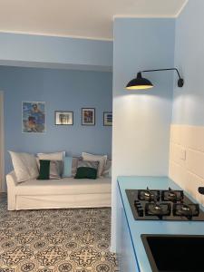 a living room with a couch and a stove at Case Borgo vacanze Bouganville in Letojanni