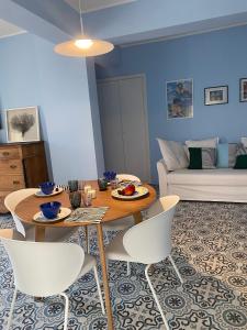 a living room with a table and chairs and a couch at Case Borgo vacanze Bouganville in Letojanni