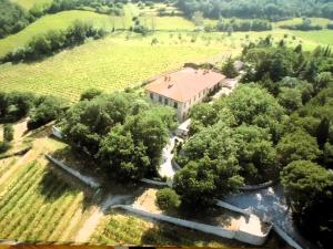 an aerial view of a house in a field with trees at Hotel Villa Casalecchi in Castellina in Chianti