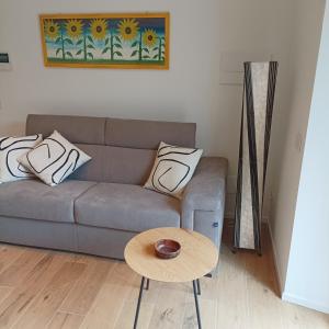 a living room with a couch and a table at APPARTAMENTO LA FUCINA in Molina di Ledro