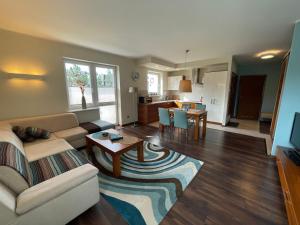 a living room with a couch and a table at Apartament Słoneczny na Krzywej in Wisła