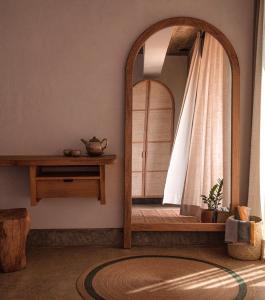a mirror in the corner of a room with a window at Casa Ukiyo in San Agustinillo +37 photos