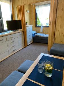 a living room with a table with glasses on it at Domki Letniskowe Jarek in Rowy +28 photos