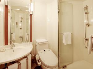 a bathroom with a toilet and a sink and a shower at ibis Ambassador Insadong in Seoul