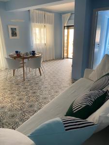 a bedroom with a bed and a table and a dining room at Case Borgo vacanze Bouganville in Letojanni