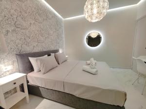 a bedroom with a bed with a teddy bear on it at Volos Guesthouse Chrysa in Volos