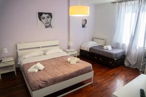 a bedroom with two beds in a room at A I R Rettifilo Apartments in Naples