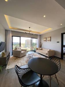 a living room with a couch and a table and chairs at Luxury Westlands 2 bedroom Apt (Escada 403) in Nairobi