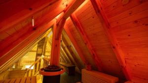 an attic view of a wooden cabin with a window at Fließ Paradies mit Blockbohlensauna in Leipe