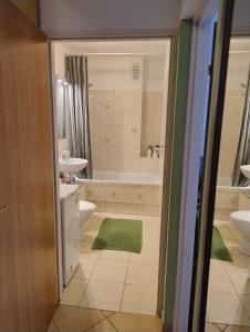 a bathroom with a tub and a toilet and a sink at GreenApartament in Krakow +12 photos