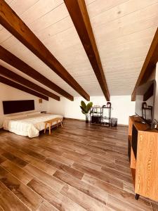 a bedroom with a bed and a wooden floor at A casa di Alberta B&B Relais in Rotondella