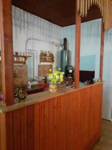 a kitchen with a wooden counter top with flowers on it at Cabana Valea Stanciului Stefan in Răchiţele