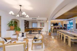 a large living room with a table and chairs at Casa La Piñata 7BR - Concierge and Maid Included in Cabo San Lucas