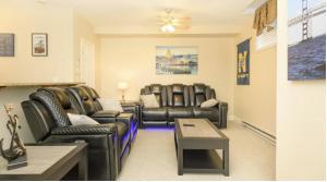 a living room with leather chairs and a table at Bay Ridge unit by Downtown Annapolis and Quiet Waters Park in Annapolis