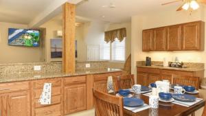 a kitchen with a table with chairs and a tv at Bay Ridge unit by Downtown Annapolis and Quiet Waters Park in Annapolis