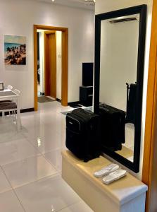 a room with a mirror and some luggage on a counter at Deluxe Flat in Muscat